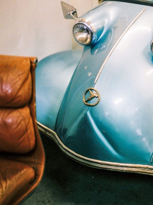 Brown-leather-lounge-and-blue-car-front Brown-leather-lounge-and-blue-car-front